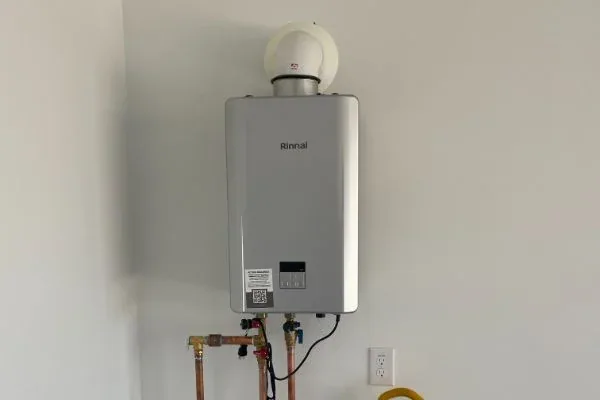 Rinnai tankless water heater installed indoors with copper supply lines